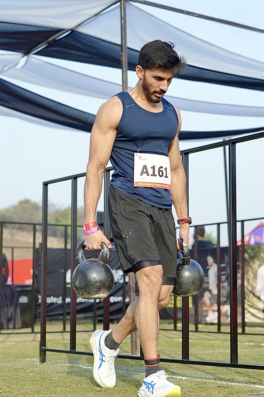 Siddharth Rana carrying kettlebells during an event